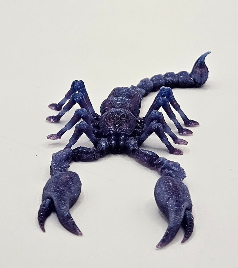 Purple scorpion figure on a white background